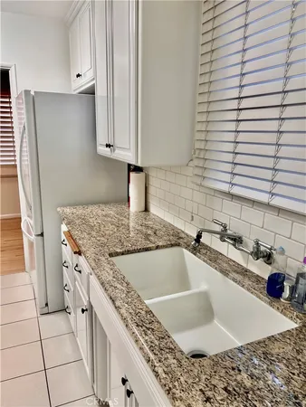 a kitchen with granite countertop a sink and a stove