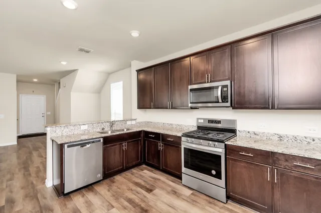 a kitchen with a refrigerator and a window