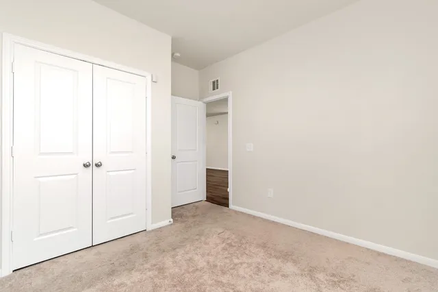 an empty room with an entryway and fireplace