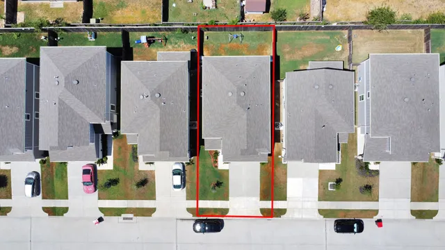 an aerial view of residential houses with outdoor space