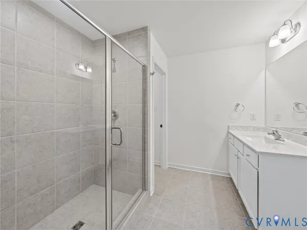 a bathroom with a double vanity sink mirror and shower