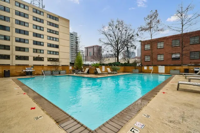 a view of a swimming pool with a lawn chairs