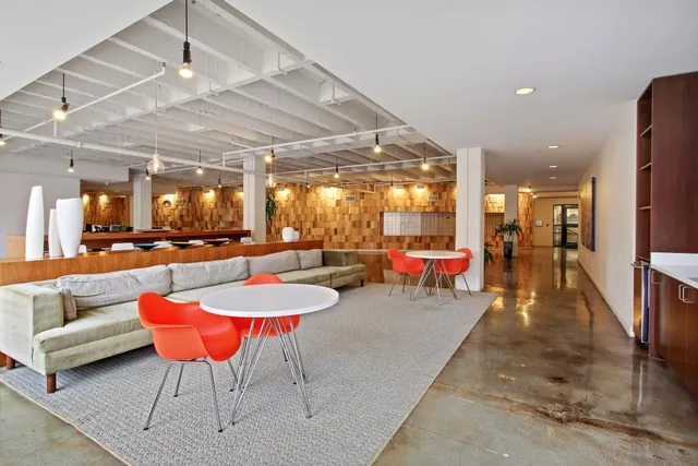 a lobby with furniture and a table