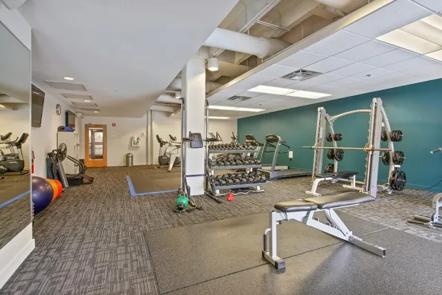 a room with gym equipment and a large window