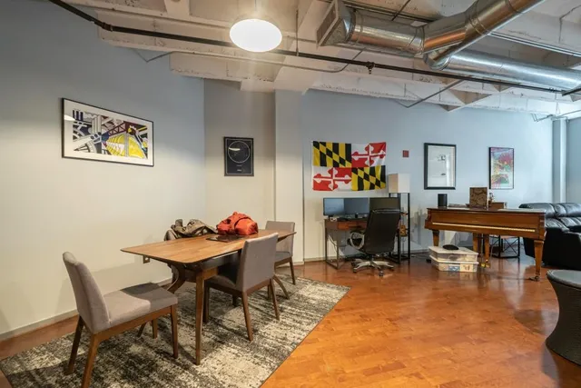 a view of a dining room with furniture and a chandelier