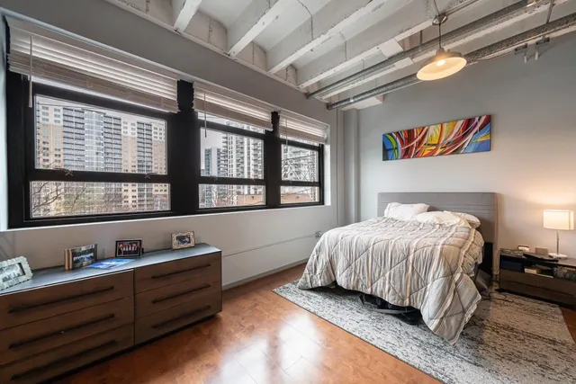 a bedroom with a bed and a window