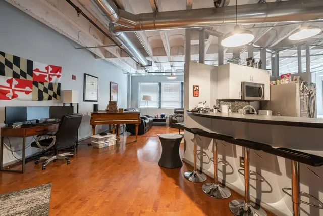 a living room with lots of furniture and a chandelier