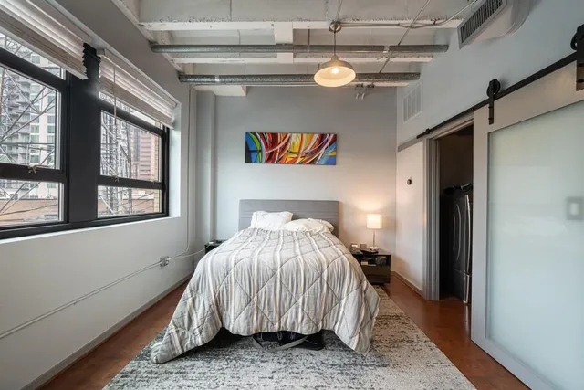 a bedroom with a bed and window