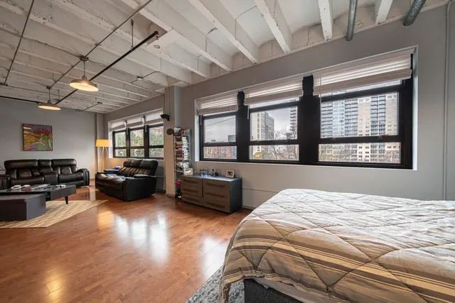 a bedroom with furniture window and flat screen tv