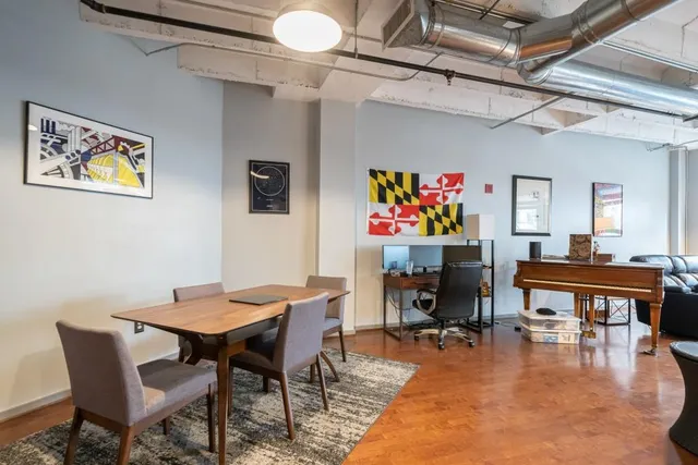 a dining room with furniture and wooden floor