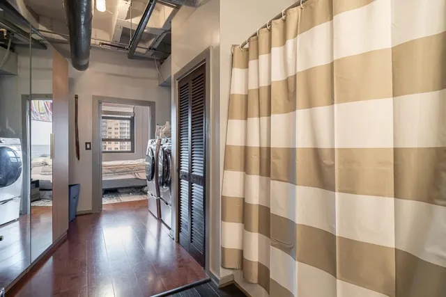 a view of a hallway and wooden floor