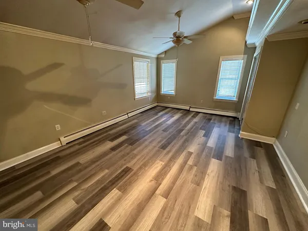 a view of room with window and wooden floor
