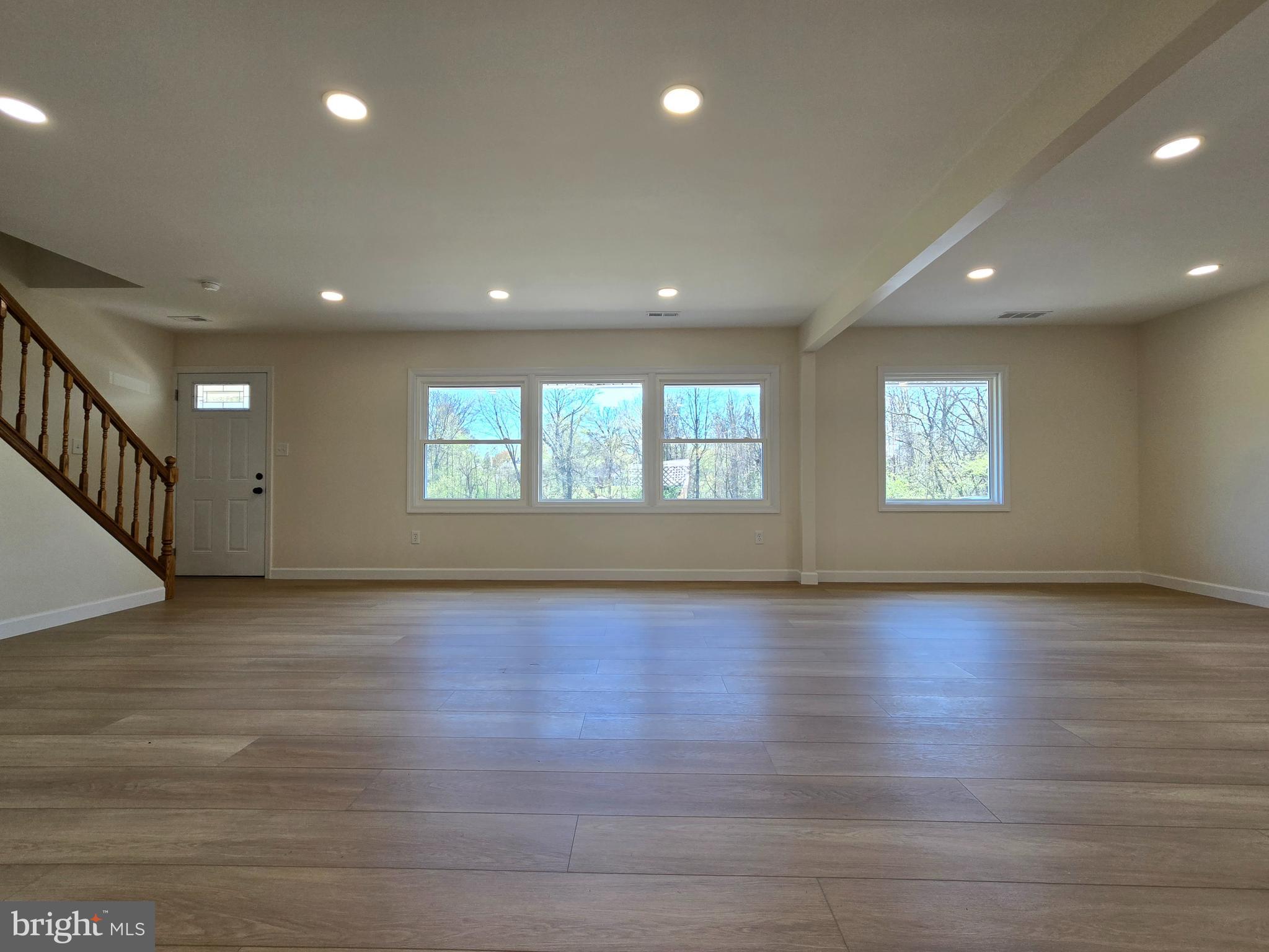 61 Cobalt Cross Road Levittown, PA 19057 - Photo 6 of 30 a view of an empty room with wooden floor and a window
