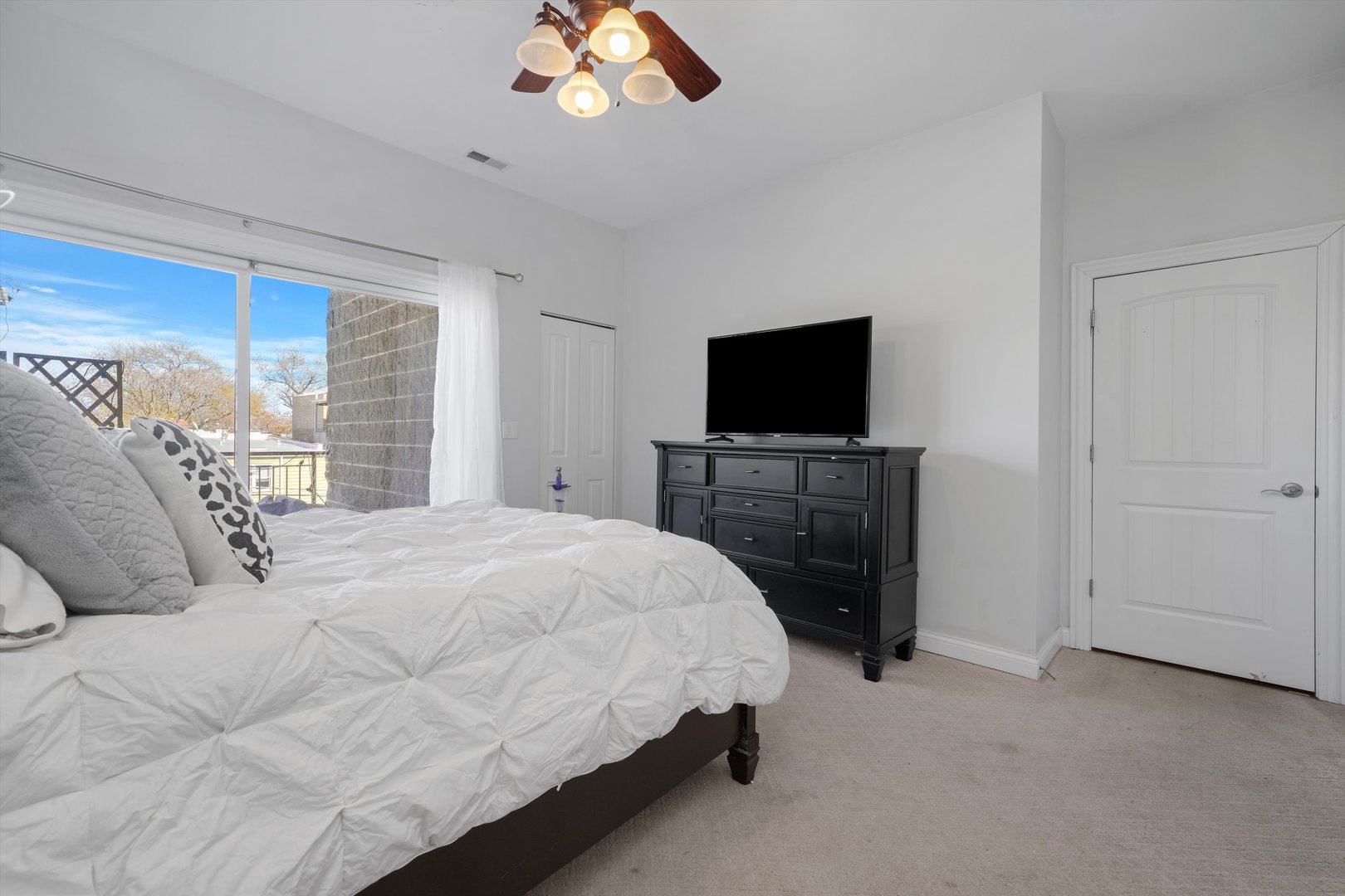 2847 North Pulaski Road, Unit 2N Chicago, IL 60641 - Photo 8 of 17 a bedroom with a bed and a flat screen tv