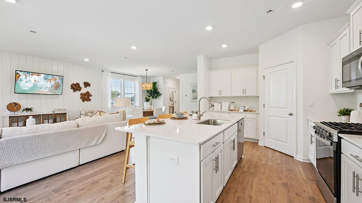 401 Scotty Boulevard, Unit 1106 Rio Grande, NJ 08242 - Photo 21 of 46 a open kitchen with stainless steel appliances granite countertop a lot of counter space and wooden floors