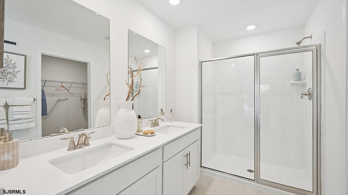 401 Scotty Boulevard, Unit 1106 Rio Grande, NJ 08242 - Photo 33 of 46 a bathroom with a double vanity sink mirror and double
