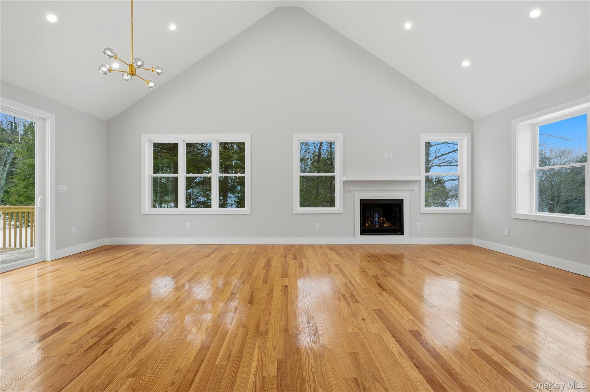 15 Manchester Road Rock Hill, NY 12775 - Photo 4 of 46 a view of empty room with wooden floor and fireplace