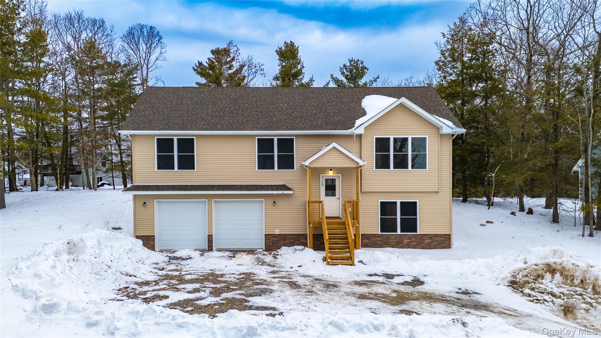 15 Manchester Road Rock Hill, NY 12775 - Photo 45 of 46 a front view of a house with a yard covered with snow