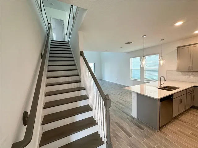 a kitchen with granite countertop a sink and a stove