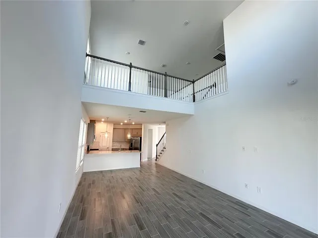 a view of a hallway with wooden floor and entryway