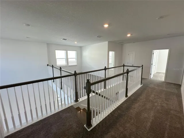 a view of a hallway with stairs
