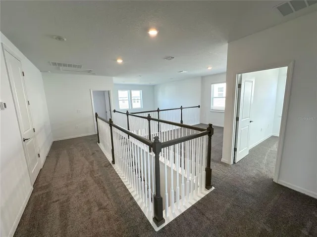 a view of a hallway with windows