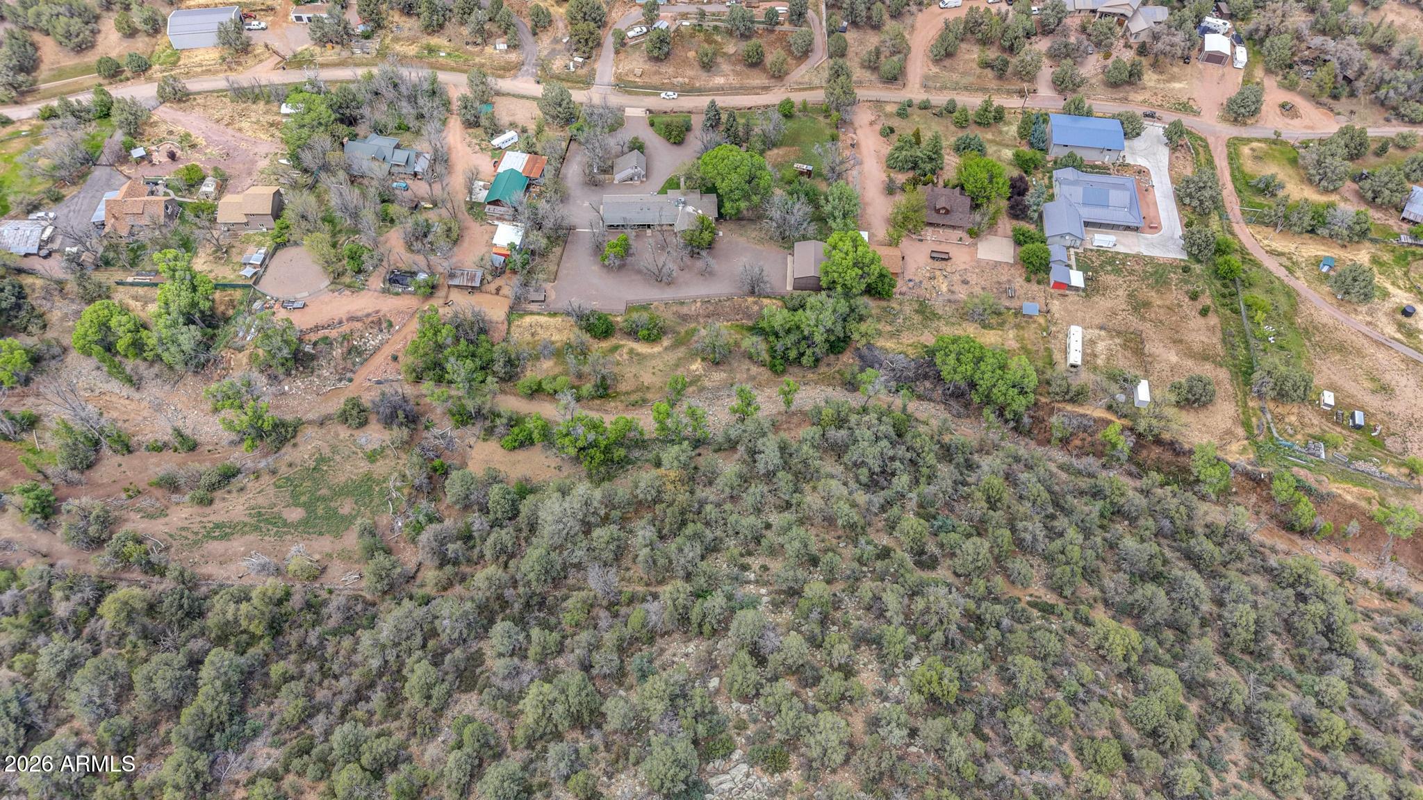 7736 West Gibson Ranch Road Payson, AZ 85541 - Photo 50 of 51 a backyard of a building with lots of trees