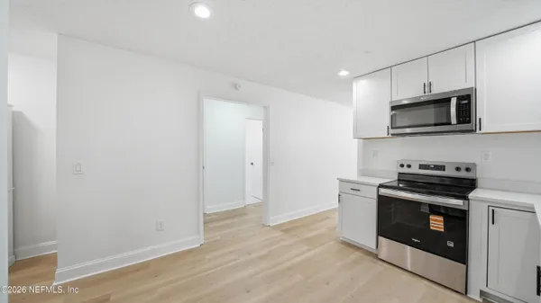 a kitchen with a stove and a microwave