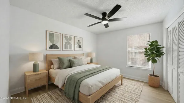 a bedroom with a large bed and a window