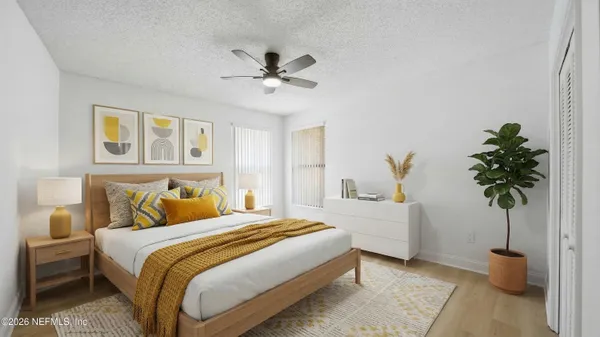 a bedroom with bed and a potted plant