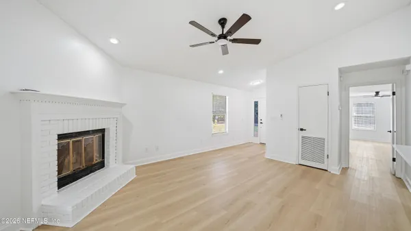 an empty room with closet and a fireplace