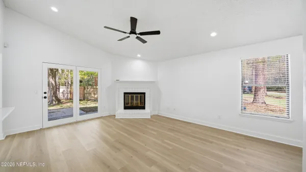 a view of a livingroom with a ceiling fan and window