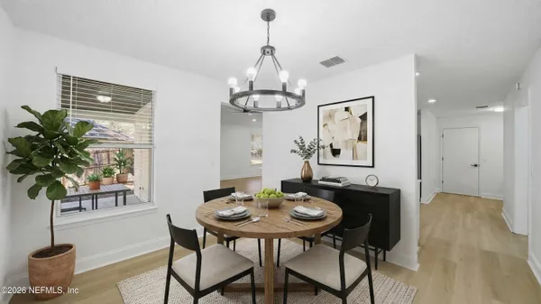 a view of a dining room with furniture window and wooden floor