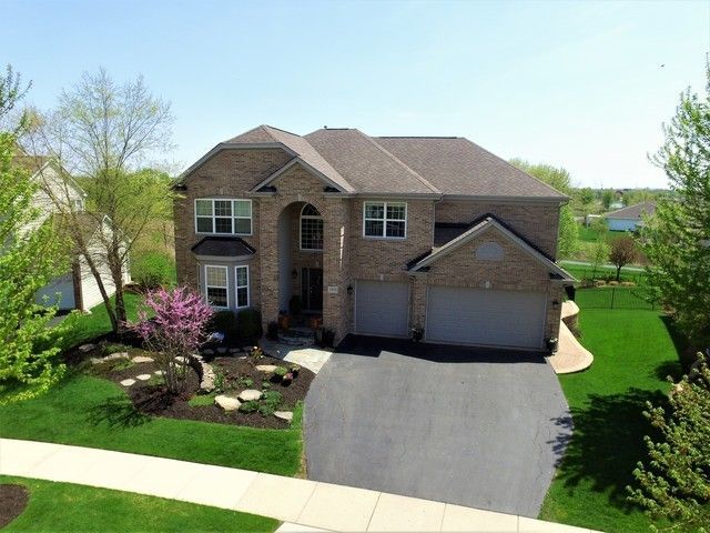 2933 Kelly Drive Elgin, IL 60124 - Photo 1 of 52 a front view of a house with a yard and garage