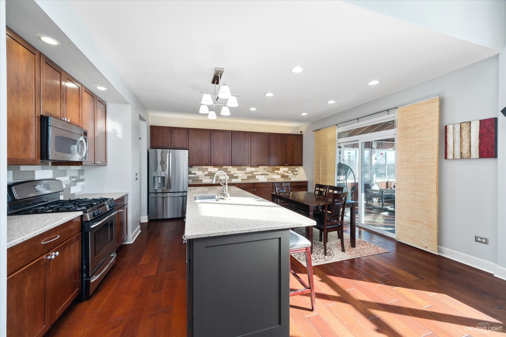 2933 Kelly Drive Elgin, IL 60124 - Photo 14 of 52 a kitchen with stainless steel appliances kitchen island granite countertop a stove and a refrigerator