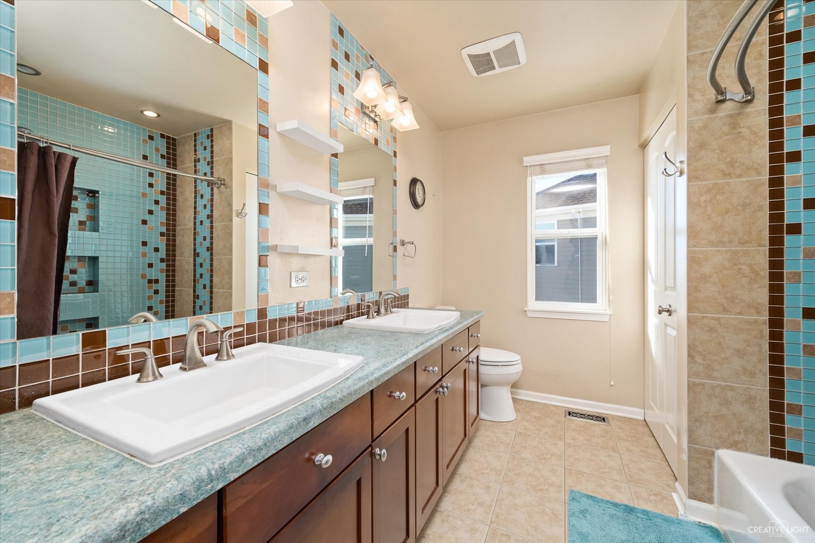 2933 Kelly Drive Elgin, IL 60124 - Photo 32 of 52 a bathroom with a granite countertop sink a toilet a mirror and a shower
