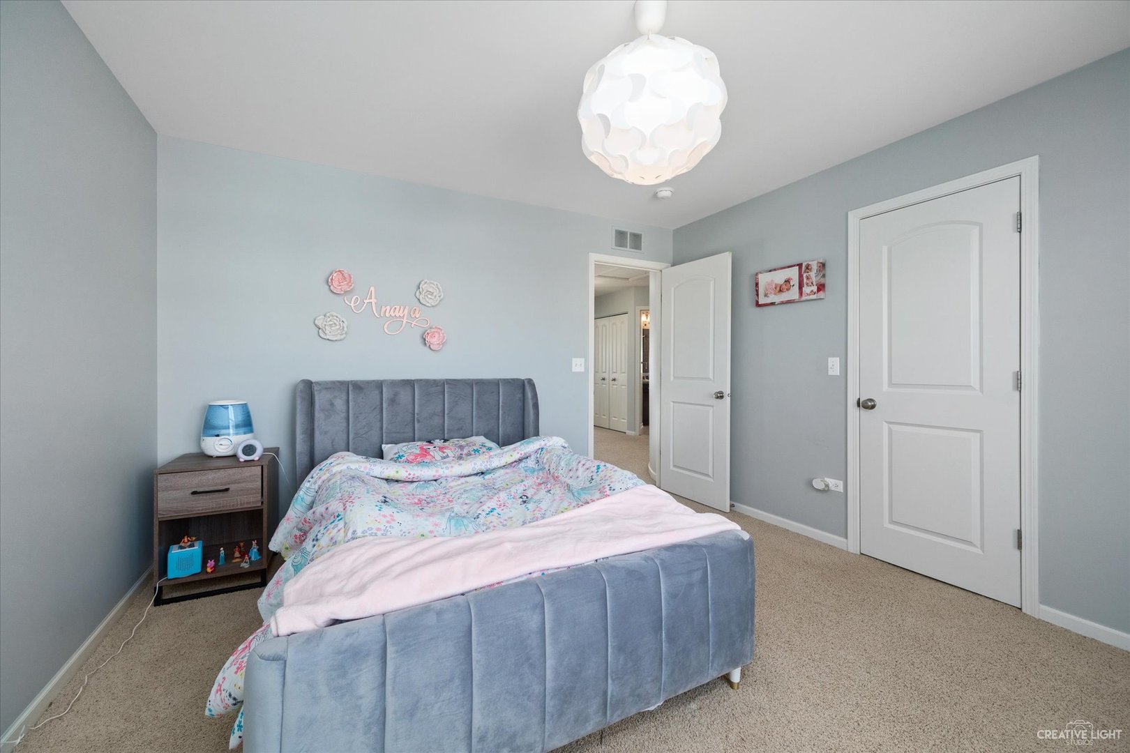 2933 Kelly Drive Elgin, IL 60124 - Photo 36 of 52 a bedroom with a bed and a chandelier