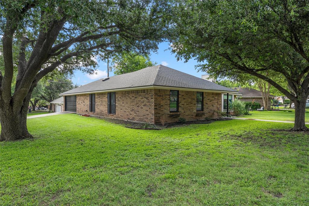 310 Ruth Drive Hewitt, TX 76643 - Photo 23 of 25 Brick exterior residence with a hip roof and dark framed windows on large corner lot in quiet neighborhood