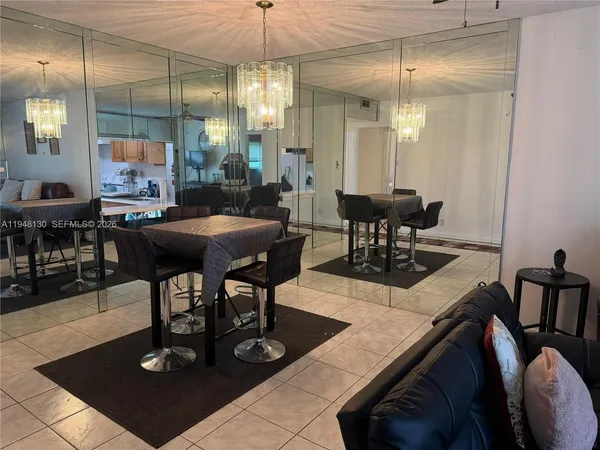 a view of a dining room with furniture and chandelier