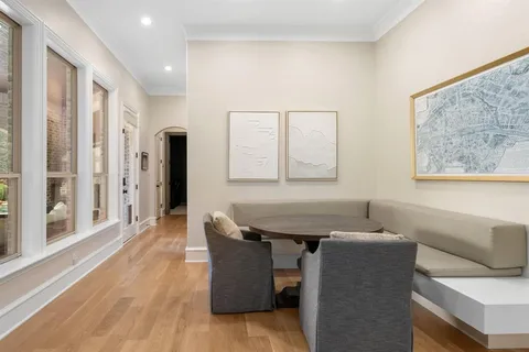 a dining room with furniture and a window