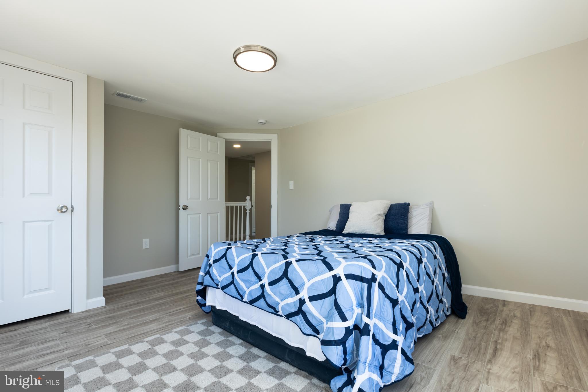 2407 Hammonds Ferry Road Halethorpe, MD 21227 - Photo 32 of 43 a bedroom with a bed and painting on the wall