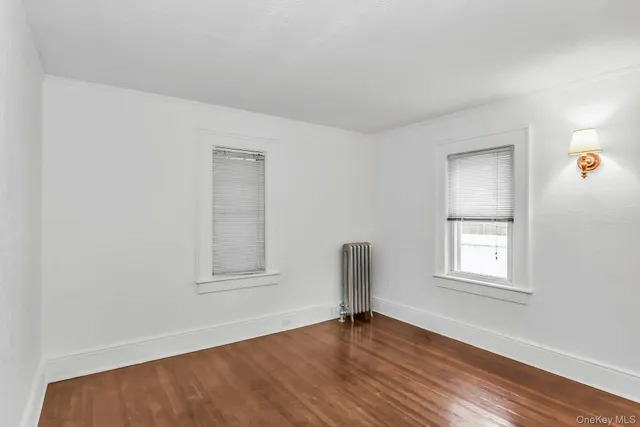 a bedroom with a large bed and a potted plant