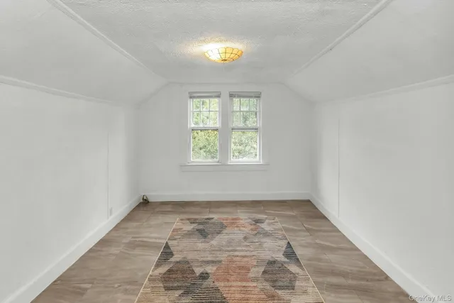 a view of hallway with stairs and a rug