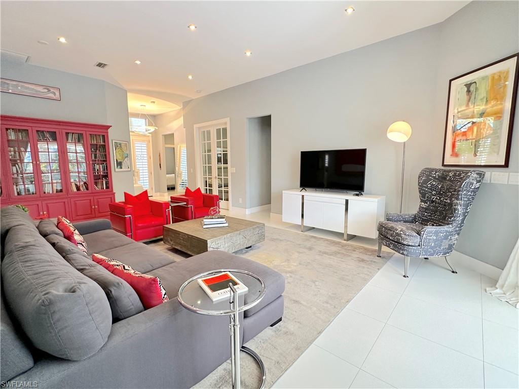 1952 Timarron Way Naples, FL 34109 - Photo 22 of 46 a living room with furniture and a flat screen tv