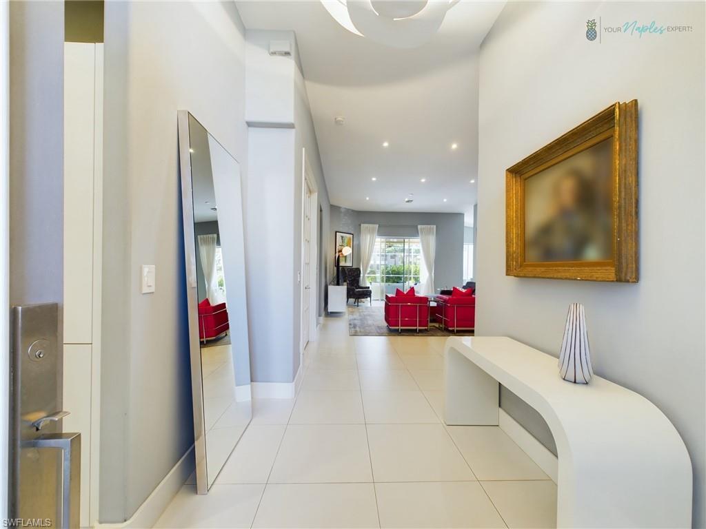 1952 Timarron Way Naples, FL 34109 - Photo 9 of 46 a view of a room with a couch and a fireplace