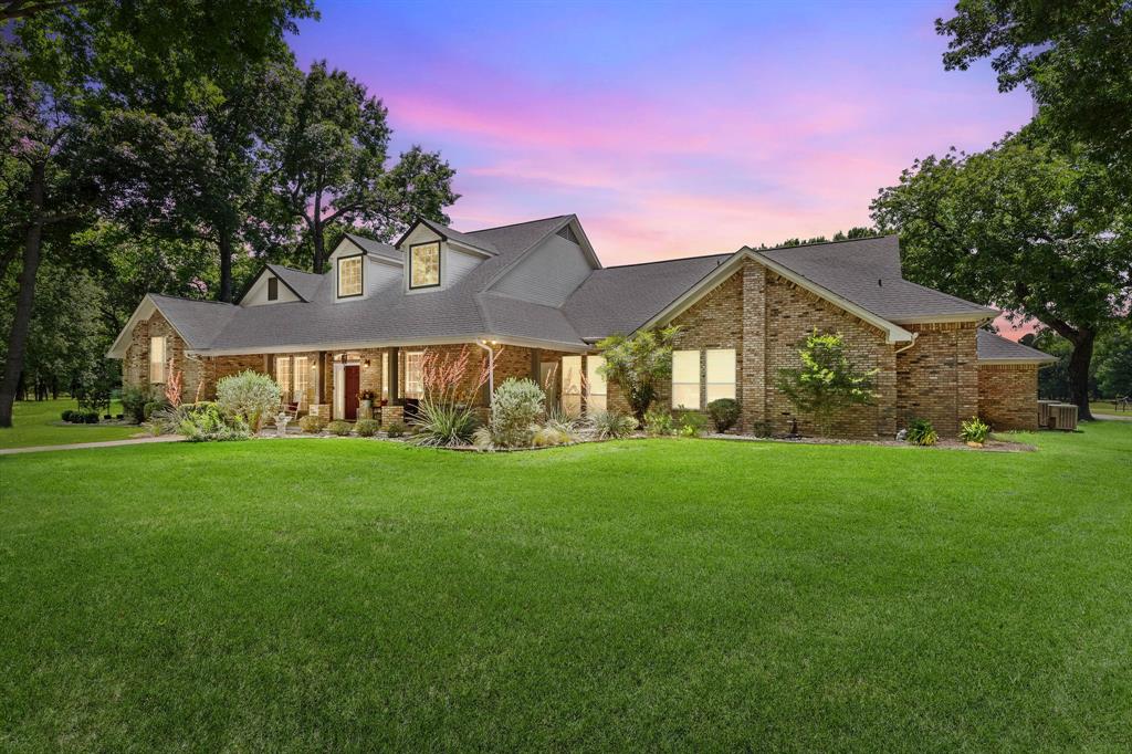145 Indian Trail Decatur, TX 76234 - Photo 3 of 40 a front view of a house with a yard