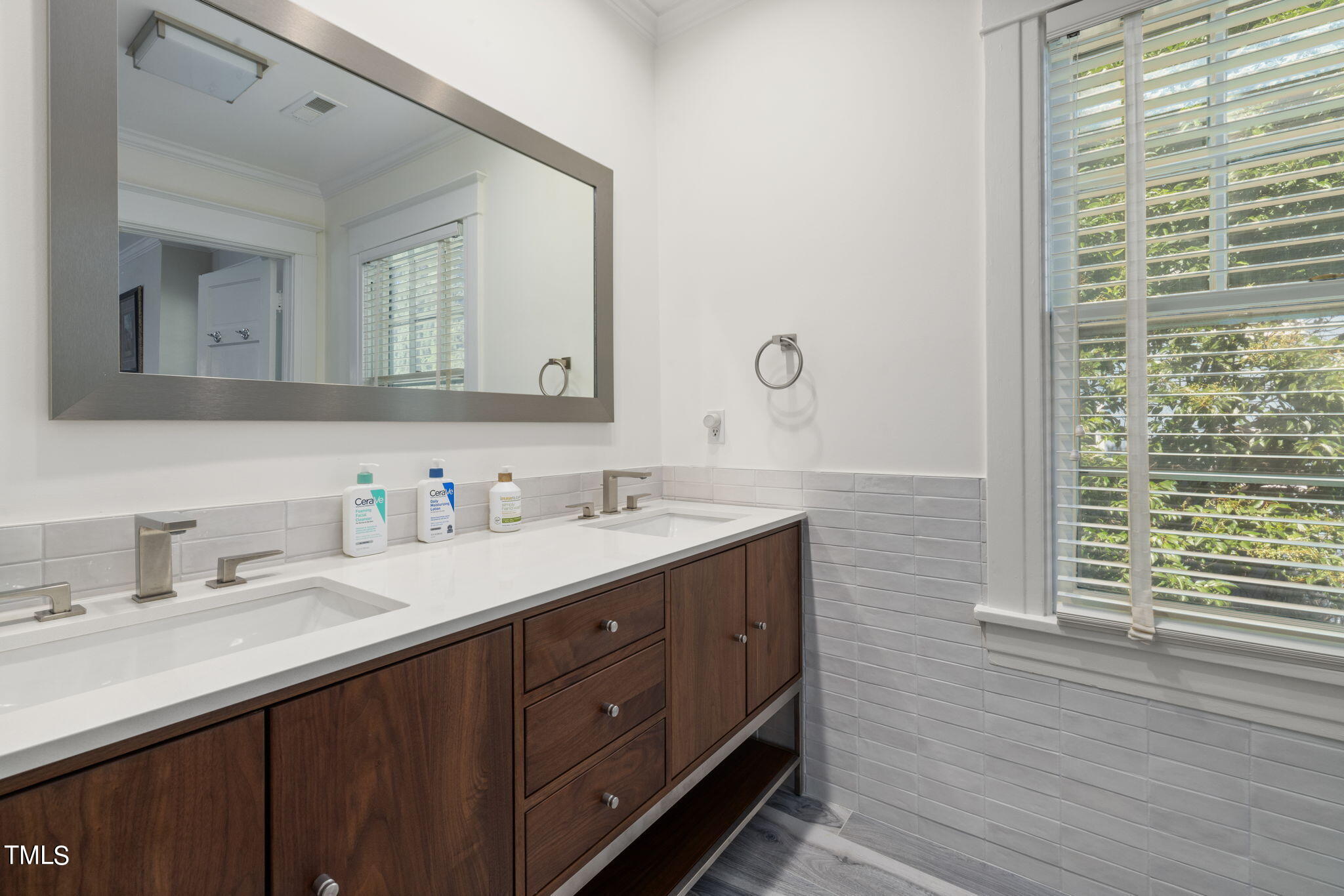 1803 White Oak Road Raleigh, NC 27608 - Photo 18 of 33 a bathroom with a double vanity sink and a mirror