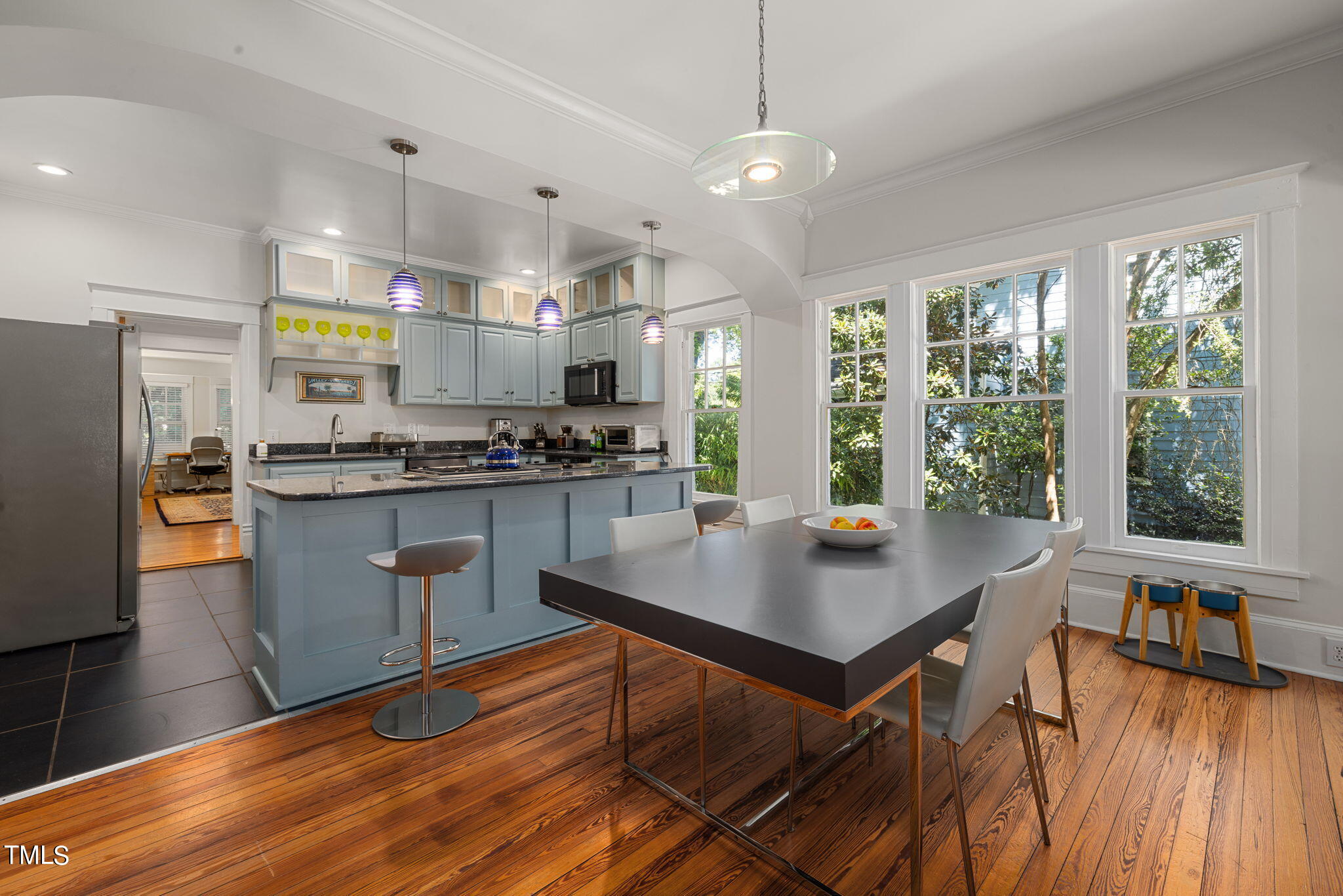1803 White Oak Road Raleigh, NC 27608 - Photo 6 of 33 a kitchen with stainless steel appliances granite countertop a stove refrigerator a dining table and chairs with wooden floor
