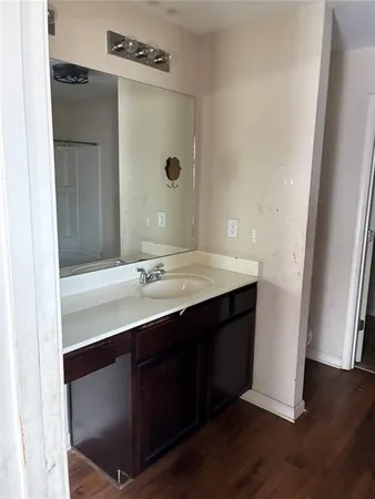 an empty room with wooden floor and entrance