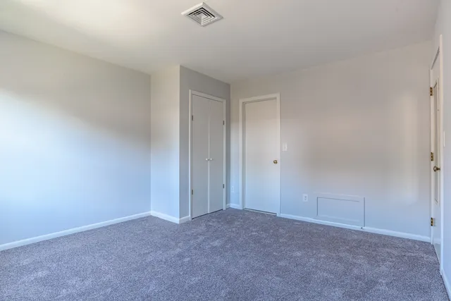 a view of an empty room and closet area